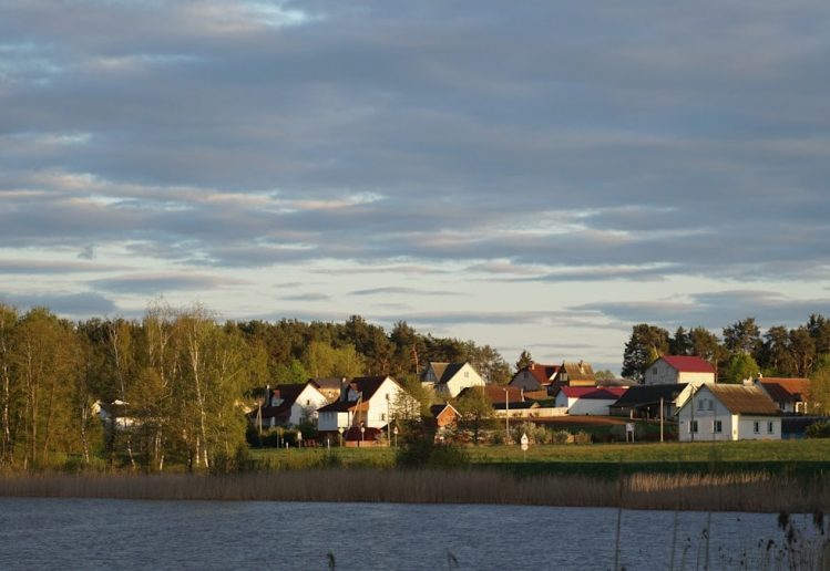 The village in the setting sun behind the lake