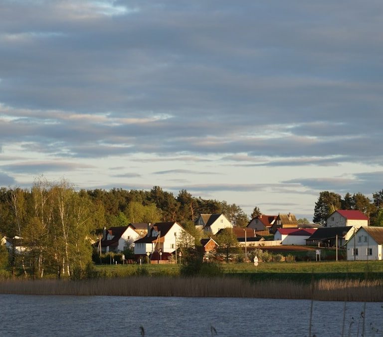 The village in the setting sun behind the lake
